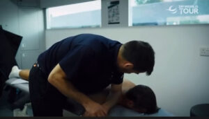 physio massaging golf player